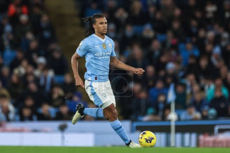 Photo for Nathan Ak of Manchester City breaks with the ball during the Premier League match Manchester City vs Burnley at Etihad Stadium, Manchester, United Kingdom, 31st January 2024 - Royalty Free Image