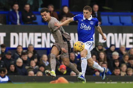 Photo for Brennan Johnson of Tottenham Hotspur crosses the ball watched by Vitaly Mykolenko of Everton during the Premier League match Everton vs Tottenham Hotspur at Goodison Park, Liverpool, United Kingdom, 3rd February 202 - Royalty Free Image