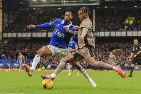 Photo for Destiny Udogie of Tottenham Hotspur is challenged by Beto of Everton during the Premier League match Everton vs Tottenham Hotspur at Goodison Park, Liverpool, United Kingdom, 3rd February 202 - Royalty Free Image