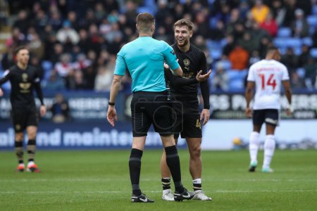 Photo for John Mcatee of Barnsley reacts to referee John Busby after he gives a free kick to Bolton during the Sky Bet League 1 match Bolton Wanderers vs Barnsley at Toughsheet Community Stadium, Bolton, United Kingdom, 3rd February 202 - Royalty Free Image