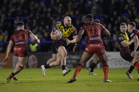 Photo for Gil Dudson of Warrington Wolves runs at Leigh Leopards defence during the Rugby League Joe Philbin Testimonial match Warrington Wolves vs Leigh Leopards at Halliwell Jones Stadium, Warrington, United Kingdom, 3rd February 202 - Royalty Free Image