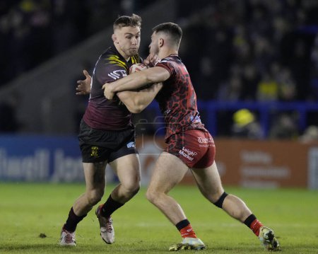 Photo for Sam Powell of Warrington Wolves runs at Lachlan Lam of Leigh Leopards during the Rugby League Joe Philbin Testimonial match Warrington Wolves vs Leigh Leopards at Halliwell Jones Stadium, Warrington, United Kingdom, 3rd February 202 - Royalty Free Image