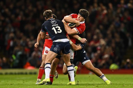 Photo for Teddy Williams of Wales is tackled by Huw Jones of Scotland and Sione Tuipulotu of Scotland during the 2024 Guinness 6 Nations match Wales vs Scotland at Principality Stadium, Cardiff, United Kingdom, 3rd February 202 - Royalty Free Image