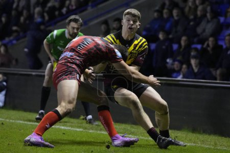 Photo for Jake Thewlis of Warrington Wolves is tackled into touch during the Rugby League Joe Philbin Testimonial match Warrington Wolves vs Leigh Leopards at Halliwell Jones Stadium, Warrington, United Kingdom, 3rd February 202 - Royalty Free Image