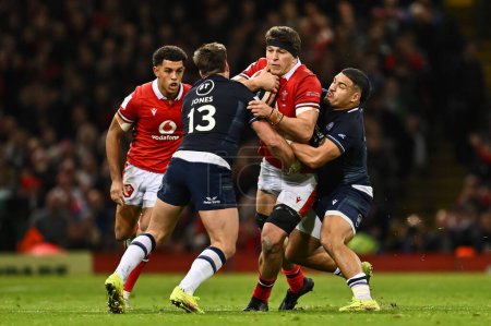 Photo for Teddy Williams of Wales is tackled by Huw Jones of Scotland and Sione Tuipulotu of Scotland during the 2024 Guinness 6 Nations match Wales vs Scotland at Principality Stadium, Cardiff, United Kingdom, 3rd February 202 - Royalty Free Image