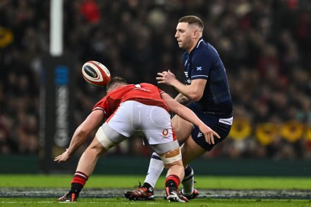 Photo for Finn Russell of Scotland offloads the ball before the tackle of Tommy Reffell of Wales during the 2024 Guinness 6 Nations match Wales vs Scotland at Principality Stadium, Cardiff, United Kingdom, 3rd February 202 - Royalty Free Image