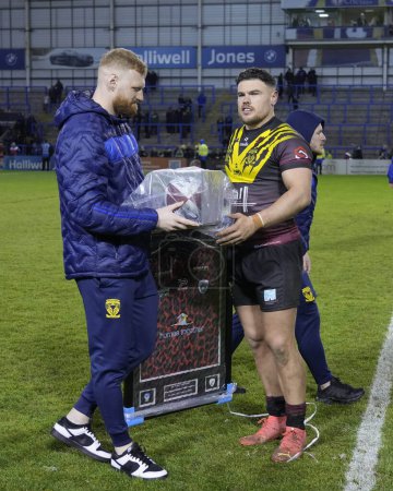 Photo for Joe Philbin of Warrington Wolves with a signed Leigh Leopards shirt and ball presented to him by Leigh Leopards after the Rugby League Joe Philbin Testimonial match Warrington Wolves vs Leigh Leopards at Halliwell Jones Stadium, Warrington, United Ki - Royalty Free Image