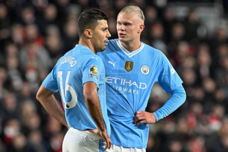 Photo for Rodri of Manchester City speaks to Erling Hland of Manchester City during the Premier League match Brentford vs Manchester City at The Gtech Community Stadium, London, United Kingdom, 5th February 2024 - Royalty Free Image