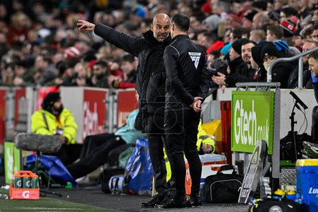 Photo for Pep Guardiola manager of Manchester City speaks to the fourth official during the Premier League match Brentford vs Manchester City at The Gtech Community Stadium, London, United Kingdom, 5th February 202 - Royalty Free Image