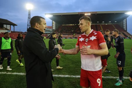 Photo for Neill Collins Head coach of Barnsley shakes hands with Sam Cosgrove of Barnsley during the Sky Bet League 1 match Barnsley vs Leyton Orient at Oakwell, Barnsley, United Kingdom, 10th February 202 - Royalty Free Image