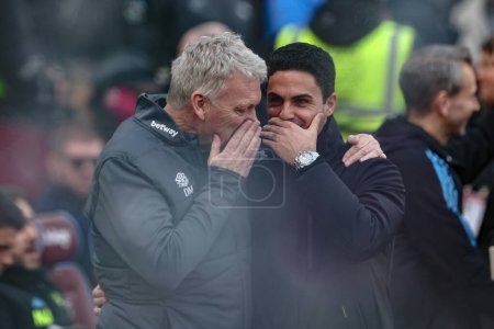 Photo for David Moyes manager of West Ham United embraces Mikel Arteta manager of Arsenal before the game during the Premier League match West Ham United vs Arsenal at London Stadium, London, United Kingdom, 11th February 202 - Royalty Free Image