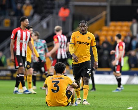 Photo for Rayan At-Nouri of Wolverhampton Wanderers and Jean-Ricner Bellegarde of Wolverhampton Wanderers reacts at full time, during the Premier League match Wolverhampton Wanderers vs Brentford at Molineux, Wolverhampton, United Kingdom, 10th February 2024 - Royalty Free Image