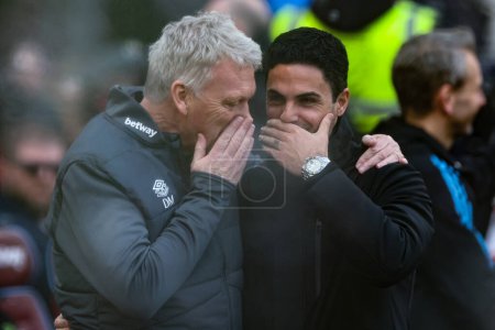 Photo for David Moyes manager of West Ham United embraces Mikel Arteta manager of Arsenal before the game during the Premier League match West Ham United vs Arsenal at London Stadium, London, United Kingdom, 11th February 202 - Royalty Free Image