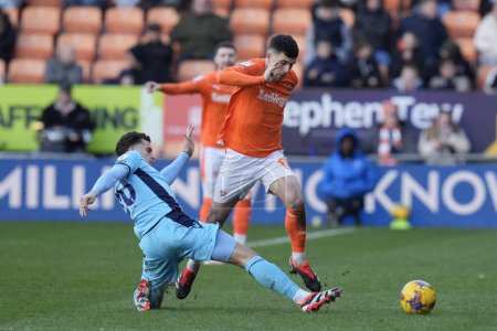 Photo for Rben Rodrigues of Oxford United tackles Albie Morgan of Blackpool during the Sky Bet League 1 match Blackpool vs Oxford United at Bloomfield Road, Blackpool, United Kingdom, 10th February 2024 - Royalty Free Image