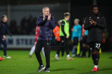 Photo for Neil Critchley manager of Blackpool applauds the travelling fans after the Sky Bet League 1 match Cheltenham Town vs Blackpool at The Completely-Suzuki Stadium, Cheltenham, United Kingdom, 13th February 202 - Royalty Free Image