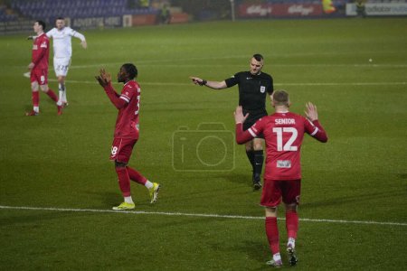 Photo for Joel Senior of Morecambe reacts as Referee Benjamin Speedie awards Rovers a penalty during the Sky Bet League 2 match Tranmere Rovers vs Morecambe at Prenton Park, Birkenhead, United Kingdom, 13th February 202 - Royalty Free Image