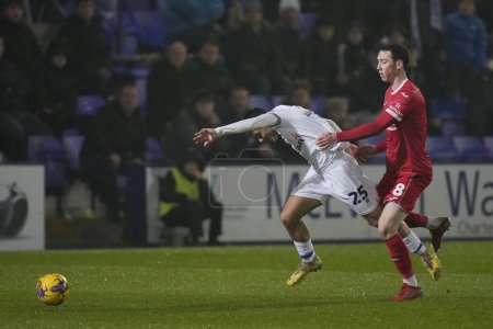 Photo for Rob Apter of Tranmere Rovers is fouled by Joe Adams of Morecambe during the Sky Bet League 2 match Tranmere Rovers vs Morecambe at Prenton Park, Birkenhead, United Kingdom, 13th February 202 - Royalty Free Image