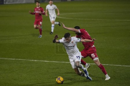 Photo for Chris Stokes of Morecambe fouls Harvey Saunders of Tranmere Rovers in the penalty area and concedes a penalty during the Sky Bet League 2 match Tranmere Rovers vs Morecambe at Prenton Park, Birkenhead, United Kingdom, 13th February 202 - Royalty Free Image