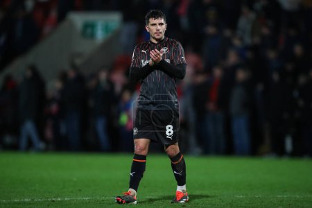 Photo for Albie Morgan of Blackpool applauds the travelling fans after the Sky Bet League 1 match Cheltenham Town vs Blackpool at The Completely-Suzuki Stadium, Cheltenham, United Kingdom, 13th February 202 - Royalty Free Image