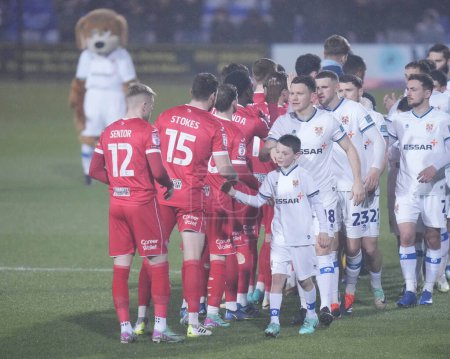 Photo for Tranmere Rovers players shake hands with Morecambe players before the Sky Bet League 2 match Tranmere Rovers vs Morecambe at Prenton Park, Birkenhead, United Kingdom, 13th February 202 - Royalty Free Image
