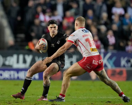 Photo for Dean Parata of London Broncos runs at Jake Wingfield of St. Helens during the Betfred Super League Round 1 match St Helens vs London Broncos at Totally Wicked Stadium, St Helens, United Kingdom, 16th February 202 - Royalty Free Image