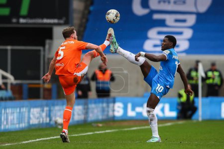 Photo for Matthew Pennington of Blackpool and Ephron Mason-Clark of Peterborough United battle for the ball during the Sky Bet League 1 match Peterborough United vs Blackpool at Weston Homes Stadium, Peterborough, United Kingdom, 17th February 202 - Royalty Free Image