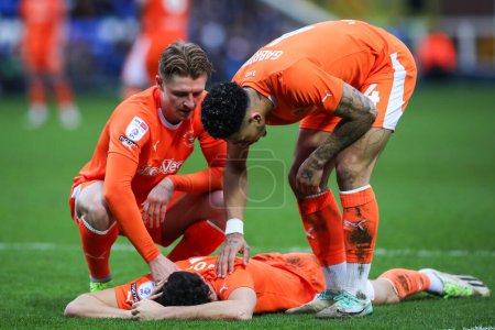Photo for George Byers of Blackpool and Jordan Lawrence-Gabriel of Blackpool check on Kyle Joseph of Blackpool after a coming together with Jed Steer of Peterborough United during the Sky Bet League 1 match Peterborough United vs Blackpool at Weston Homes Stad - Royalty Free Image