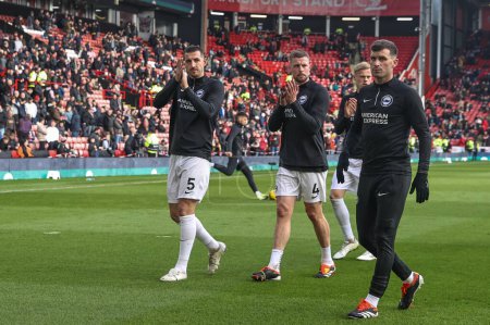 Photo for Lewis Dunk of Brighton & Hove Albion and Adam Webster of Brighton & Hove Albion applaud the fans as they warm up during the Premier League match Sheffield United vs Brighton and Hove Albion at Bramall Lane, Sheffield, United Kingdom, 18th February 20 - Royalty Free Image