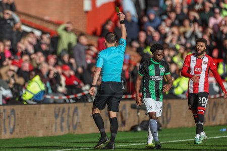 Photo for Referee Stuart Attwell gives a yellow card to Tariq Lamptey of Brighton & Hove Albion during the Premier League match Sheffield United vs Brighton and Hove Albion at Bramall Lane, Sheffield, United Kingdom, 18th February 202 - Royalty Free Image