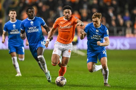 Photo for Jordan Lawrence-Gabriel of Blackpool and Archie Collins of Peterborough United battle for the ball during the Bristol Street Motors Trophy Semi-Final match Blackpool vs Peterborough United at Bloomfield Road, Blackpool, United Kingdom, 20th February - Royalty Free Image