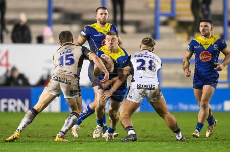Photo for Matt Dufty of Warrington Wolves is tackled by Denive Balmforth Hull FC and Jordan Lane Hull FC during the Betfred Super League Round 2 match Warrington Wolves vs Hull FC at Halliwell Jones Stadium, Warrington, United Kingdom, 23rd February 202 - Royalty Free Image