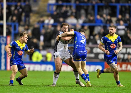 Photo for Nick Staveley Hull FC is tackled by Josh Thewlis of Warrington Wolves, during the Betfred Super League Round 2 match Warrington Wolves vs Hull FC at Halliwell Jones Stadium, Warrington, United Kingdom, 23rd February 202 - Royalty Free Image
