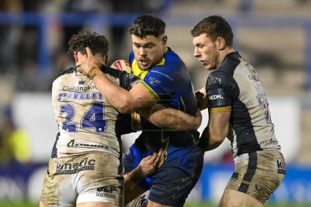Photo for Joe Philbin of Warrington Wolves is tackled by Nick Staveley Hull FC during the Betfred Super League Round 2 match Warrington Wolves vs Hull FC at Halliwell Jones Stadium, Warrington, United Kingdom, 23rd February 202 - Royalty Free Image