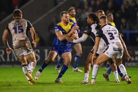 Photo for Lachlan Fitzgibbon of Warrington Wolves is tackled by Jayden Okunbor Hull FC during the Betfred Super League Round 2 match Warrington Wolves vs Hull FC at Halliwell Jones Stadium, Warrington, United Kingdom, 23rd February 202 - Royalty Free Image