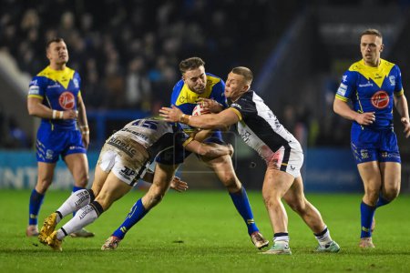 Photo for James Harrison of Warrington Wolves is tackled by Jordan Lane Hull FC during the Betfred Super League Round 2 match Warrington Wolves vs Hull FC at Halliwell Jones Stadium, Warrington, United Kingdom, 23rd February 202 - Royalty Free Image