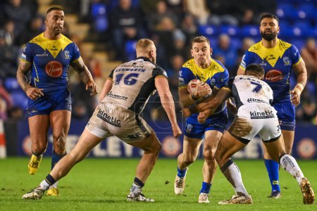 Photo for Matt Dufty of Warrington Wolves is tackled by Faamanu Brown Hull FC during the Betfred Super League Round 2 match Warrington Wolves vs Hull FC at Halliwell Jones Stadium, Warrington, United Kingdom, 23rd February 202 - Royalty Free Image