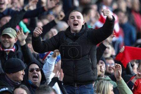 Photo for Barnsley fans celebrate a 2-1 win during the Sky Bet League 1 match Barnsley vs Derby County at Oakwell, Barnsley, United Kingdom, 24th February 202 - Royalty Free Image