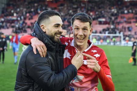 Photo for Adam Phillips of Barnsley and Mal de Gevigney of Barnsley celebrate their 2-1 win during the Sky Bet League 1 match Barnsley vs Derby County at Oakwell, Barnsley, United Kingdom, 24th February 202 - Royalty Free Image