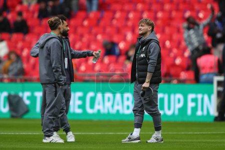 Photo for Harvey Elliott of Liverpool speaks to Mohamed Salah of Liverpool and Kostas Tsimikas of Liverpool during the Carabao Cup Final match Chelsea vs Liverpool at Wembley Stadium, London, United Kingdom, 25th February 202 - Royalty Free Image