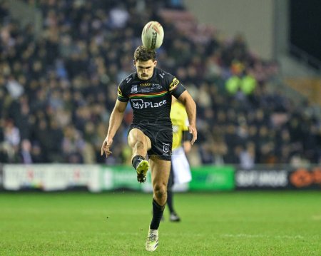 Photo for Nathan Cleary of Penrith Panthers kick the match ball, during the 2024 World Club Challenge match Wigan Warriors vs Penrith Panthers at DW Stadium, Wigan, United Kingdom, 24th February 202 - Royalty Free Image