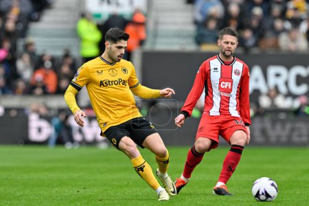 Photo for Pedro Neto of Wolverhampton Wanderers passes the ball pressured by Oliver Norwood of Sheffield United during the Premier League match Wolverhampton Wanderers vs Sheffield United at Molineux, Wolverhampton, United Kingdom, 25th February 202 - Royalty Free Image