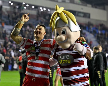 Photo for Patrick Mago of Wigan Warriors celebrates with Mighty Max mascot of Wigan Warriors, during the 2024 World Club Challenge match Wigan Warriors vs Penrith Panthers at DW Stadium, Wigan, United Kingdom, 24th February 202 - Royalty Free Image