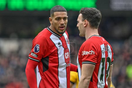 Photo for Vinicius Souza of Sheffield United speaks to Jack Robinson of Sheffield United during the Premier League match Wolverhampton Wanderers vs Sheffield United at Molineux, Wolverhampton, United Kingdom, 25th February 202 - Royalty Free Image