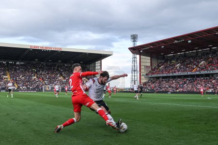 Photo for Jordan Williams of Barnsley and Eiran Cashin of Derby County battle for the ball during the Sky Bet League 1 match Barnsley vs Derby County at Oakwell, Barnsley, United Kingdom, 24th February 202 - Royalty Free Image