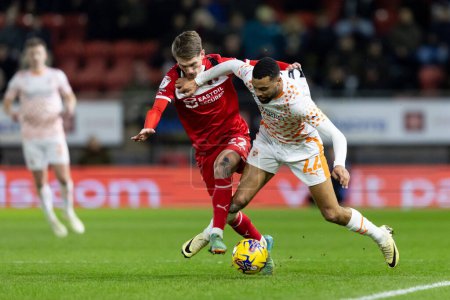Photo for CJ Hamilton of Blackpool  and Ethan Galbraith of Leyton Orient battle for the ball during the Sky Bet League 1 match Leyton Orient vs Blackpool at Matchroom Stadium, London, United Kingdom, 27th February 202 - Royalty Free Image