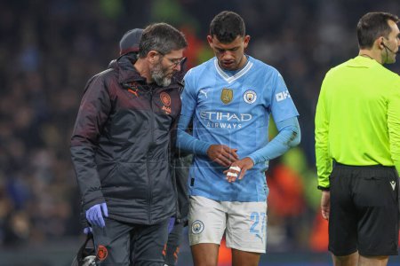 Photo for Matheus Nunes of Manchester City comes away from his injury with his fingers taped up during the UEFA Champions League match Manchester City vs F.C. Copenhagen at Etihad Stadium, Manchester, United Kingdom, 6th March 202 - Royalty Free Image
