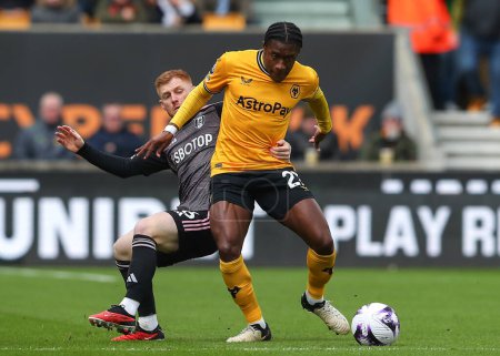 Photo for Harrison Reed of Fulham tackles Jean-Ricner Bellegarde of Wolverhampton Wanderers, during the Premier League match Wolverhampton Wanderers vs Fulham at Molineux, Wolverhampton, United Kingdom, 9th March 202 - Royalty Free Image