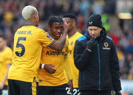 Photo for Mario Lemina of Wolverhampton Wanderers comforts Jean-Ricner Bellegarde of Wolverhampton Wanderers as he is substituted, during the Premier League match Wolverhampton Wanderers vs Fulham at Molineux, Wolverhampton, United Kingdom, 9th March 202 - Royalty Free Image