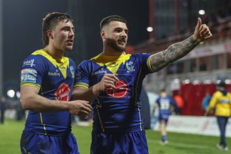 Photo for Connor Wrench of Warrington Wolves and Adam Holroyd of Warrington Wolves celebrate with the fans after winning the game during the Betfred Super League Round 4 match Hull KR vs Warrington Wolves at Sewell Group Craven Park, Kingston upon Hull, United - Royalty Free Image