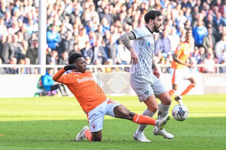 Photo for Karamoko Dembele of Blackpool is tackled by Marlon Pack of Portsmouth during the Sky Bet League 1 match Blackpool vs Portsmouth at Bloomfield Road, Blackpool, United Kingdom, 9th March 202 - Royalty Free Image